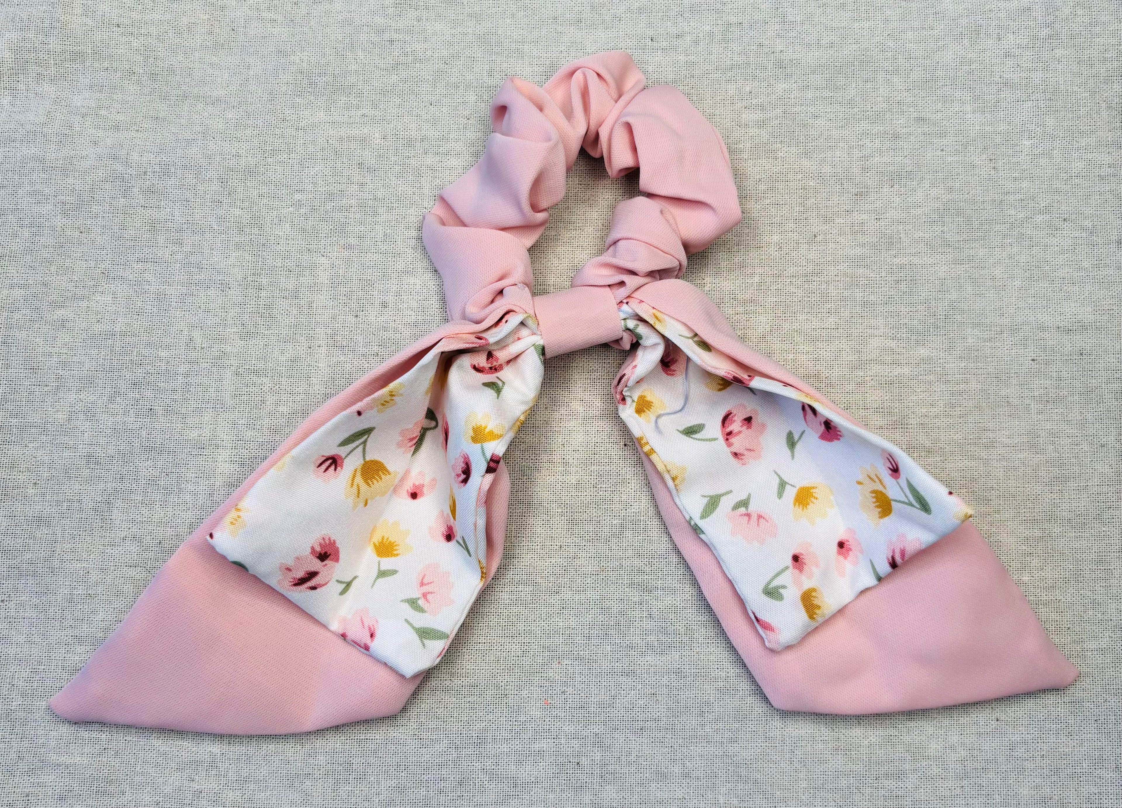 Scrunchie met speelse strik, pastelkleuren en bloemenprint